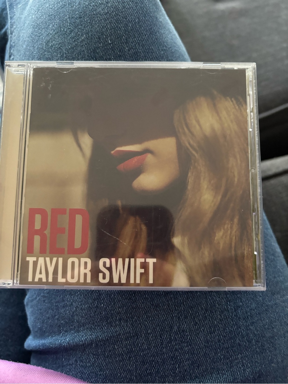 Taylor Swift Red album cover with red lips and warm brown tones
